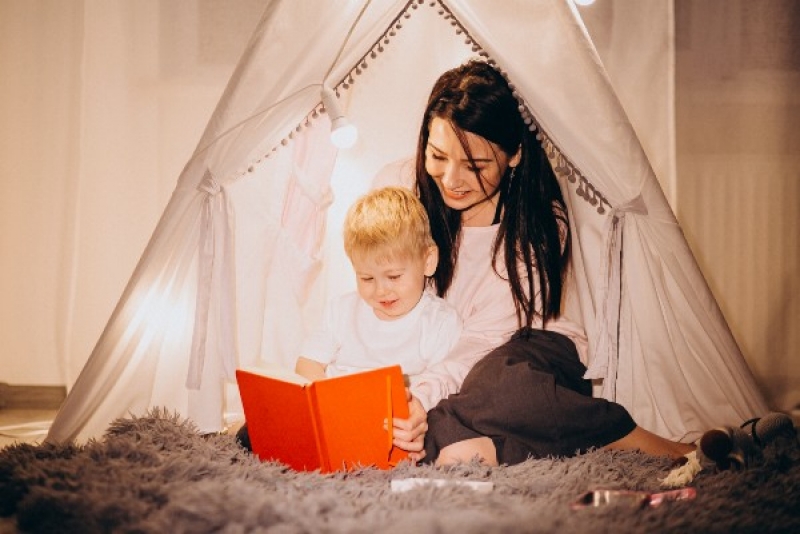 mother-with-son-sitting-cozy-tent-with-lights-home-christmas_re.jpg